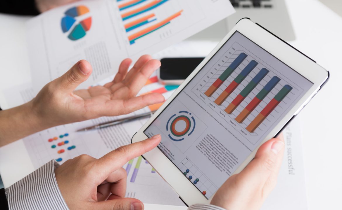 Close-up of  business team using digital tablet with financial d